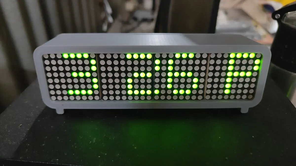 Green four-panel LED dot matrix clock in a grey 3D-printed case